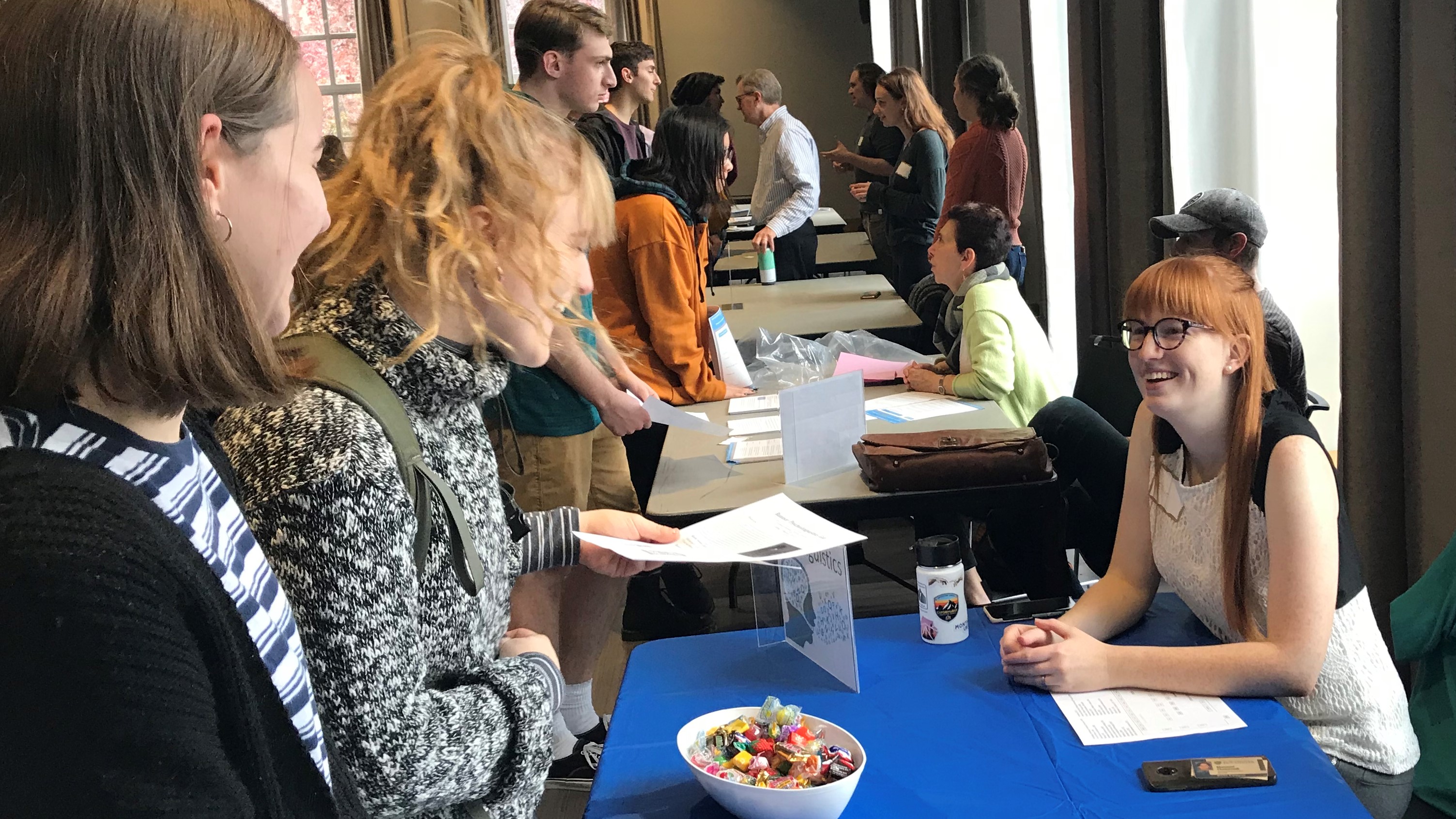Ellise talking to students at a research fair